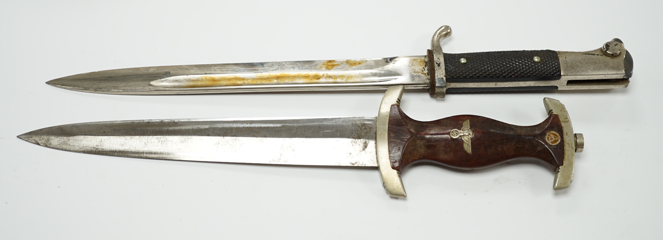 A WWII German SA dagger, regulation pattern in its steel scabbard with regulation nickel mounts, and leather hanging band and a German dress bayonet by Paul Seilheimer. Condition - fair, some wear